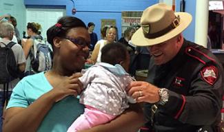 state trooper playing with a baby