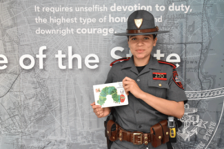 Trooper Alvarez reading "The Very Hungry Caterpillar"