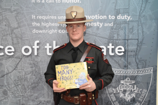 Detective Hopkins reading "Too Many Frogs"