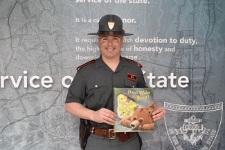 Detective Kyle Shibley reading "Don't Wake The Bear"
