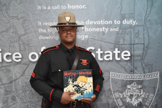 Corporal Tilson reading "Harry and Horsie"